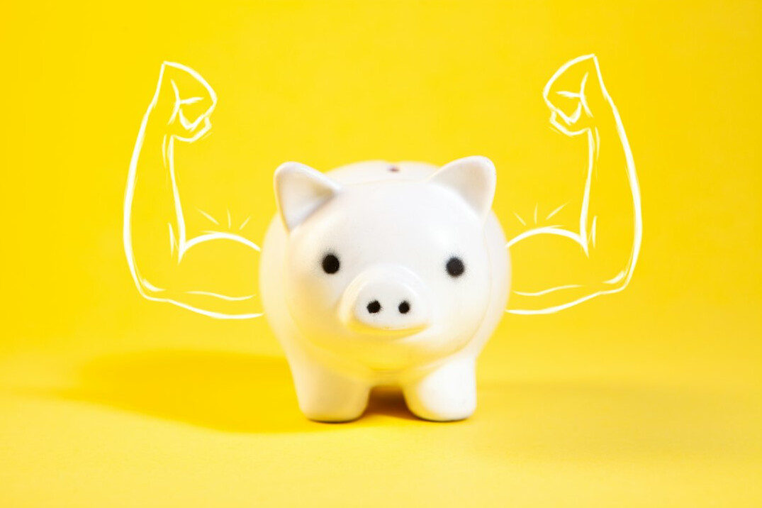 family saving money in piggy bank