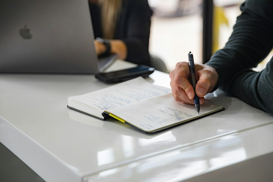 person writing budget notes