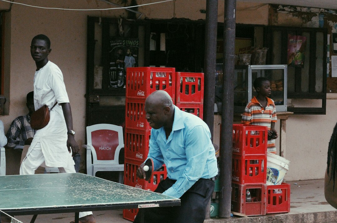 Older man organizing household documents and folders at a table